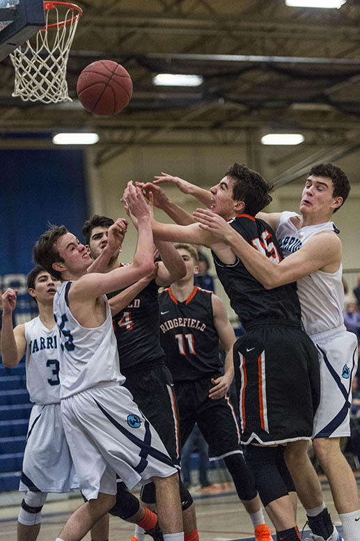 Wilton and Ridgefield players battle for a rebound during Tuesday's game. (Photo: Mark Conrad)